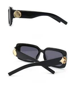 Detail view showing side and back angles of black marble pattern sunglasses with gold accents