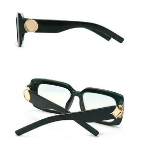 Detail view of dark green marble sunglasses featuring elegant golden metal temple joints
