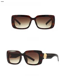 Close-up of leopard print sunglasses featuring gold metal accents and brown gradient lenses