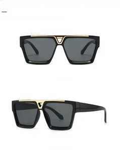 Close-up of retro flat top sunglasses with distinctive V-shaped gold metal bridge detail