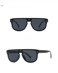 Detail of oversized flat top sunglasses with black frame and stylish metal rivets