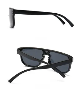Detail of black sunglasses featuring metal studs and unique V-shaped metal bridge