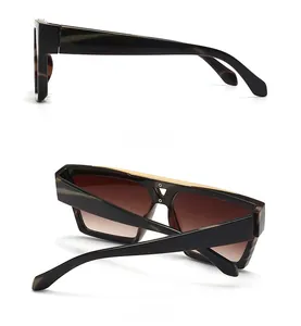 Detail view of tortoiseshell frame sunglasses with gold metal top bar and screw accents