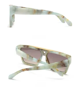 Detail of blue marble texture frame with golden metal trim on trendy square sunglasses