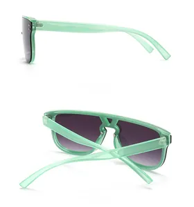 Detail view of mint green oversized sunglasses with metallic rivets and side profile design