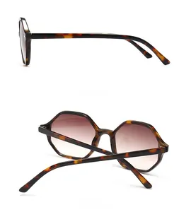 Macro view of tortoiseshell hexagonal frame details and gradient brown lenses
