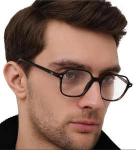 Detail of hexagonal optical frames with black front and tortoiseshell temples on model