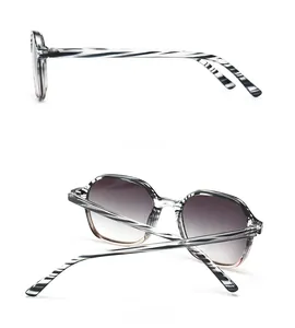 Detail view of tortoiseshell frame glasses with side and back angles and gradient lenses