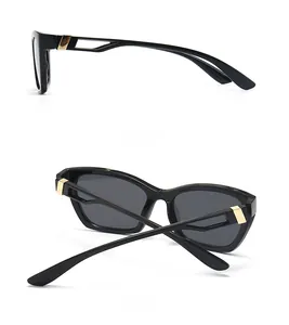 Detail of cat eye sunglasses showing hollow gold metal temples and black frame profile