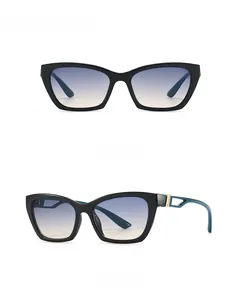 Detail view of cat eye sunglasses featuring black frames and blue gradient lenses