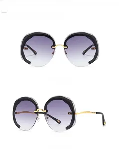 Detailed front and side views of gold metal round sunglasses with grey gradient lenses