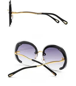 Side and back view of round oversized sunglasses with gradient lenses and gold metal frame