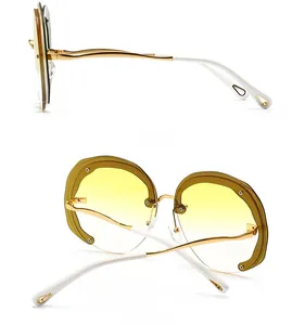 Detailed side and back view of oversized round sunglasses with gold metal frame