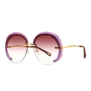 Oversized round sunglasses with gold wave temples and purple gradient lenses