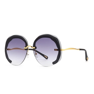 Retro oversized round sunglasses with purple gradient lenses and gold wavy metal temples
