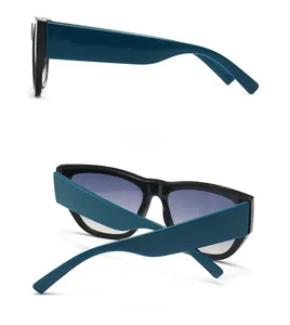 Detail view of retro cat-eye sunglasses with wide dark green temples and gradient lenses