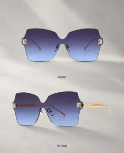 Detail van randloze vlinderzonnebril met blauwe verloopglazen en goudkleurige veren