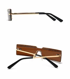 Detail of rimless rectangle sunglasses with brown lenses and crystal embellishments