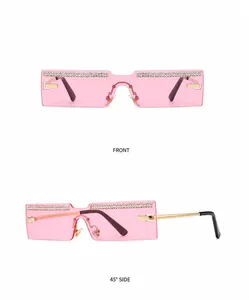 Detail view of rimless rectangular sunglasses with gold-pink lenses and rhinestone decor
