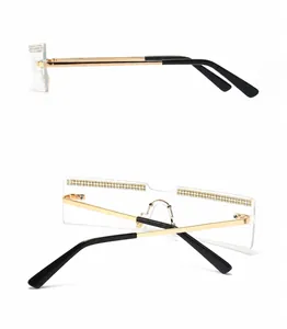 Detail view of gold metal temples and sparkling rhinestone trim on rimless sunglasses