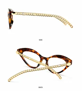 Dettaglio di occhiali cat-eye retrò con montatura tartarugata e aste a catena dorata
