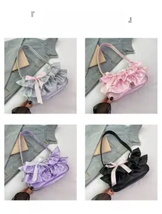 Detail view of satin ruffled handbags with decorative bows in silver pink purple and black