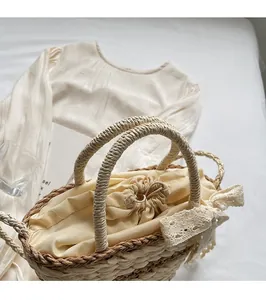 Close-up of woven straw handbag featuring a beige drawstring liner and white lace bow