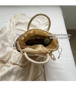 Macro view of woven straw bucket bag showing spacious interior with drawstring lining