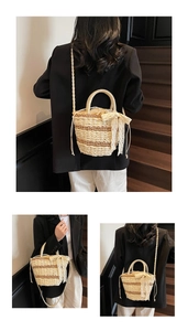 Detail of woven straw bucket bag featuring lace bow decoration and drawstring closure