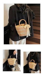 Detail of woven straw bucket bag with white lace bow and drawstring inner lining