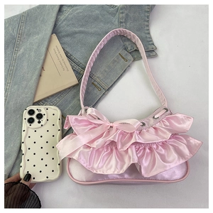 Detailed view of pink satin tote bag with ruffle trim and decorative bow elements