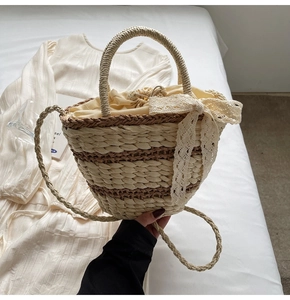 Detailed shot of straw bucket bag with drawstring liner and lace bow decoration