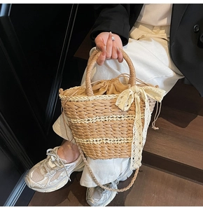 Detailed macro view of straw bucket bag texture with lace bow and drawstring inner