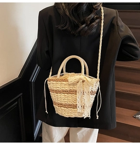Detailed macro view of woven straw bucket bag with delicate lace bow decoration
