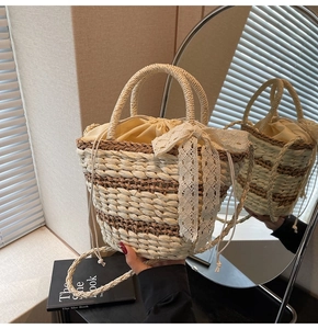 Close-up of woven straw bucket bag featuring a large lace bow and drawstring closure