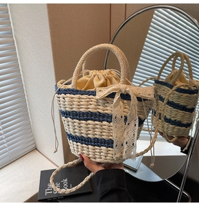 Detail of blue striped woven bucket bag featuring lace bow and drawstring closure