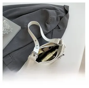 Top view of white leather underarm bag showing large capacity for phone and cosmetics