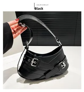 Detail of black punk style shoulder bag with glossy leather and silver metal buckles