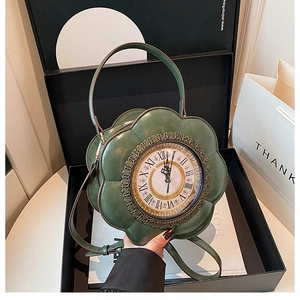 Detailed view of dark green flower shaped clock handbag with vintage metal dial and handle