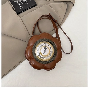 Close-up of vintage brown clock-shaped floral handbag with Roman numeral dial on a blazer