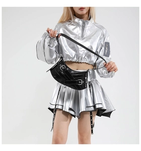 Close-up of black crescent shoulder bag with silver buckles and glossy Y2K finish
