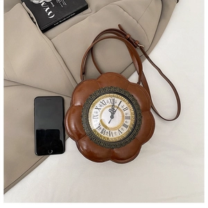 Detail of vintage brown clock-shaped floral handbag with Roman numeral dial display