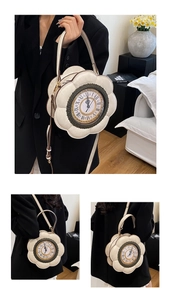 Macro view of clock-shaped cream floral handbag with Roman numeral dial and gold hardware