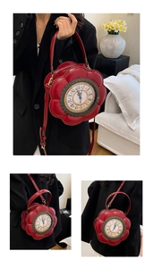 Detail view of red flower-shaped crossbody bag with vintage clock dial and Roman numerals
