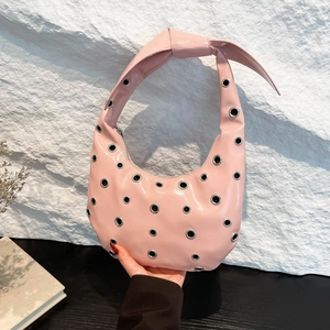 Pink patent leather crescent hobo bag with silver metallic eyelets and knotted strap