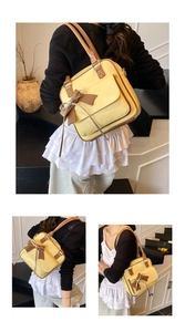 Detailed close-up of a beige JK style handbag with brown bow and long tassel detail