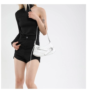 Detailed view of white chic motorcycle bag with silver buckles and leather straps