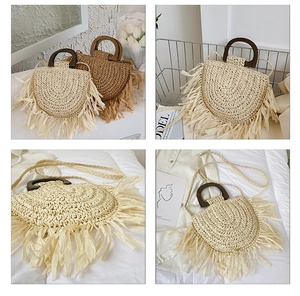 Detail view of woven straw tote bags with long fringe trim and wooden handles