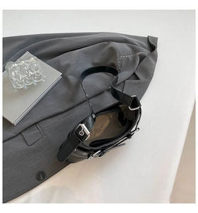 Detail of the black chic handbag interior with light lining and secure zipper pocket