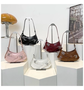 Chic semi-circular underarm bags displayed in five colors on minimalist geometric stands